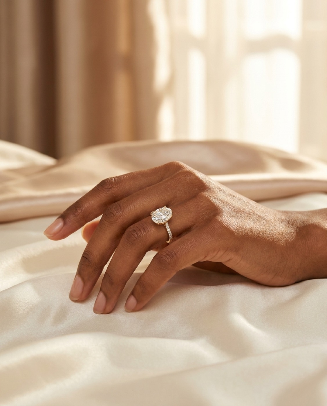 Custom gold solitaire ring on a client's hand